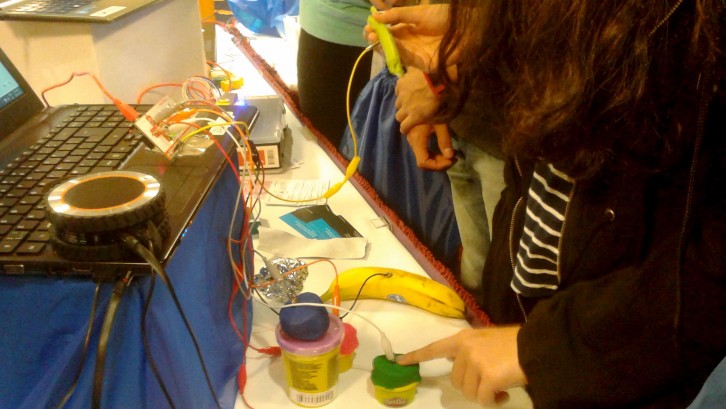 Students use Play-Doh and other objects as touchpads with the Makey Makey. 