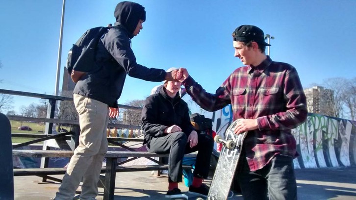 Sam Greenberg greets a friend as Tristan Connellan looks on. They skate at the Halifax Commons every day.