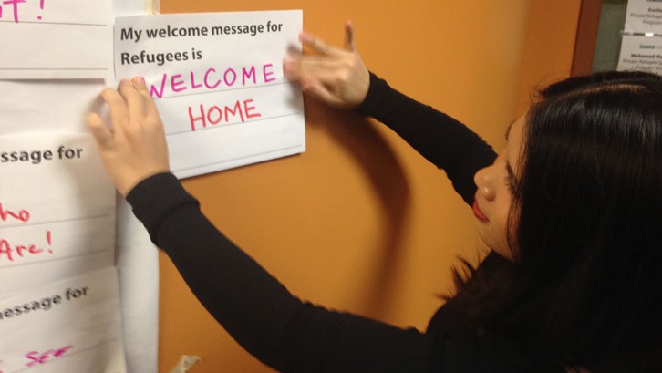 Open house attendees leave a message for future refugee arrivals.