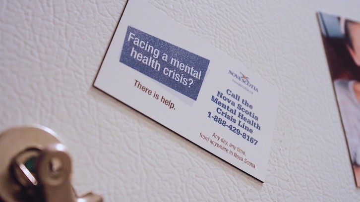 A fridge magnet with the phone number to the province's mental health crisis line.