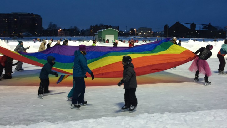 With Lady Gaga's hit song "Born This Way," playing through the loudspeakers, skaters paraded around the Oval with a huge rainbow banner.