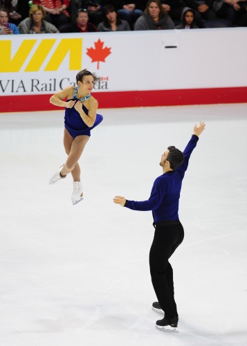 Meagan Duhamel being thrown into a spin by Eric Radford