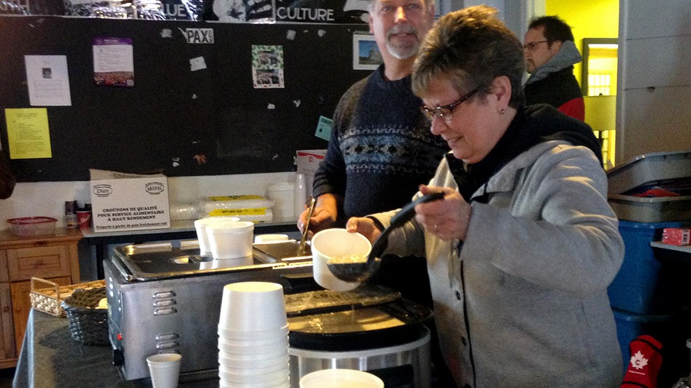 Volunteers serve soup to guests at Souls Harbour Rescue Mission.