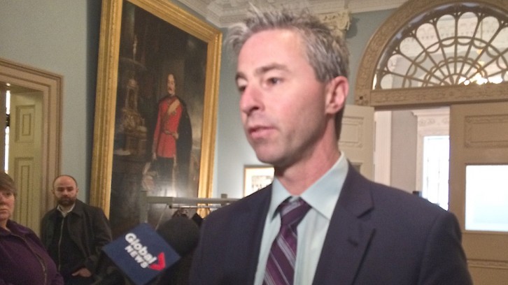MLA Tim Houston answers media questions after committee meeting