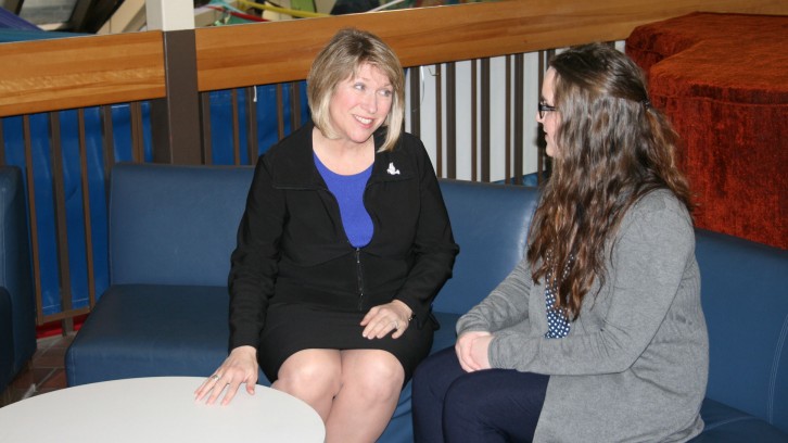 Minister Responsible for Youth Kelly Regan speaks with former summer student Jennifer West