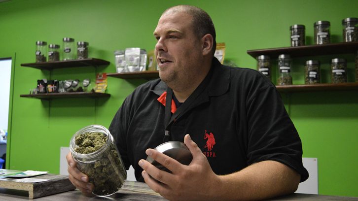 Mal McMeekin displays dried marijuana that he sells to medical patients at his store, Tasty Budd's 