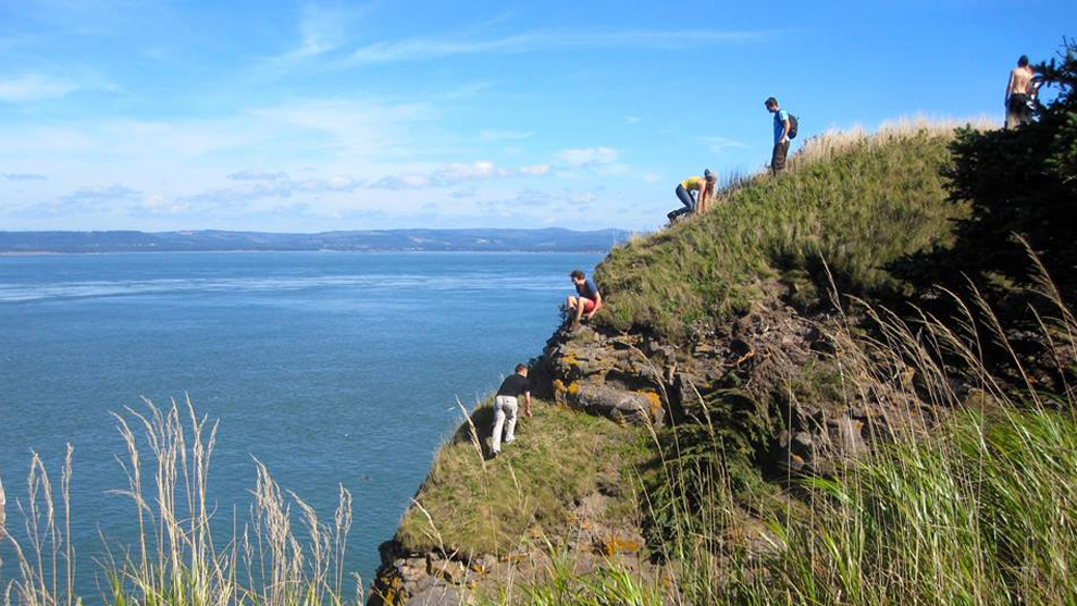 Hikers on a cliff at Cape Split