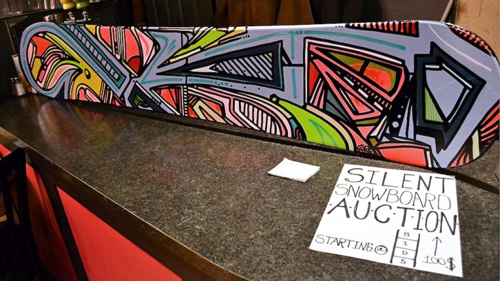 A used snowboard painted by Andrew MacKeen for the silent auction at the Broken Deck Art Show. 