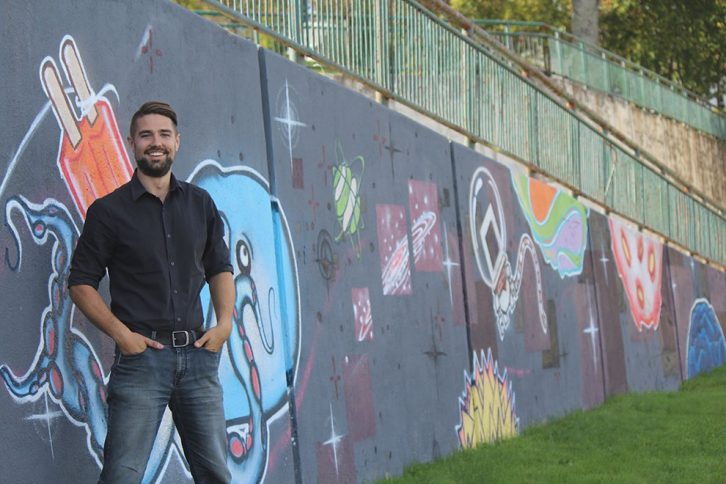 After talking with community members, Brenden Sommerhalder stands beside the Lovebot mural in Mulgrave Park - just a few streets down from where he lives.