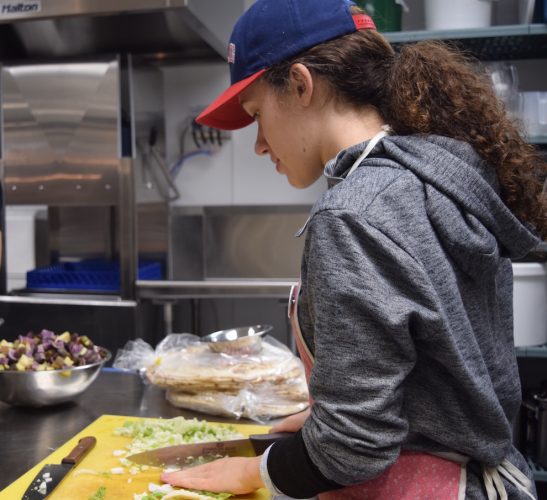 Volunteer Carly Mayhew-Gallant chops veggies during the Loaded Ladle’s weekly meal prep. 