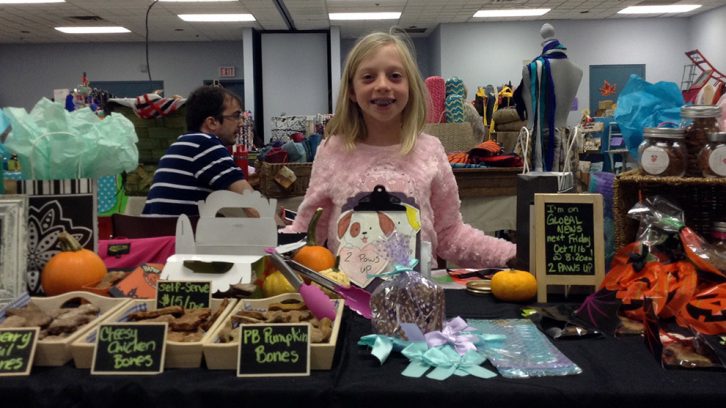 Madison Crawford stands at her table during the HRM Moms Fall Craft Market on Sunday