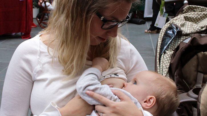 Nicole Loveless breastfeeds her daughter, Bella, as part of the Quintessence Breastfeeding Challenge.
