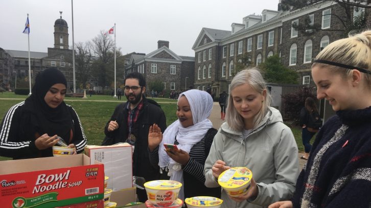 Students hand out bowls of ramen noodles in Dalhousie's Studley campus quad. 