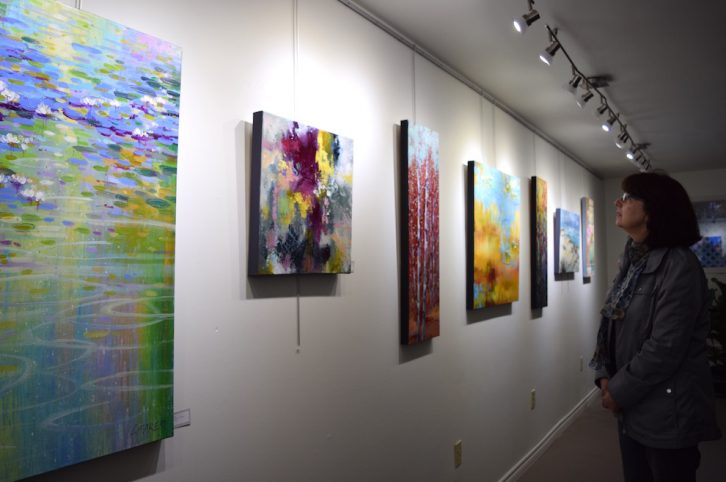Louise Baker’s art collection includes a mixture of scenic and abstract paintings. 