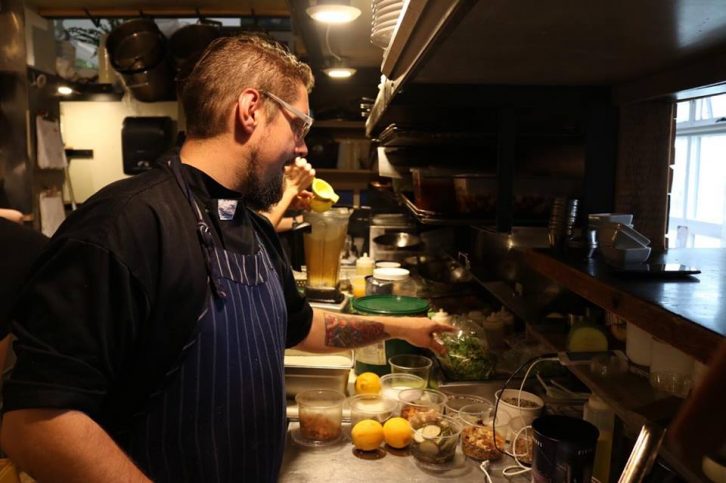 EnVie chief Todd Bright prepares food for dinner service.