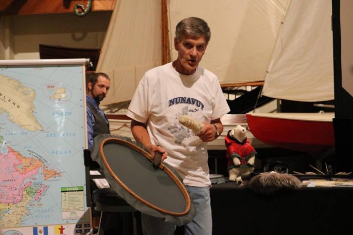 Newbery shows the audience an Inuit drum made of Labrador cloth. 