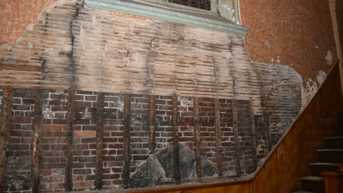 Damage on a wall near the bell tower 