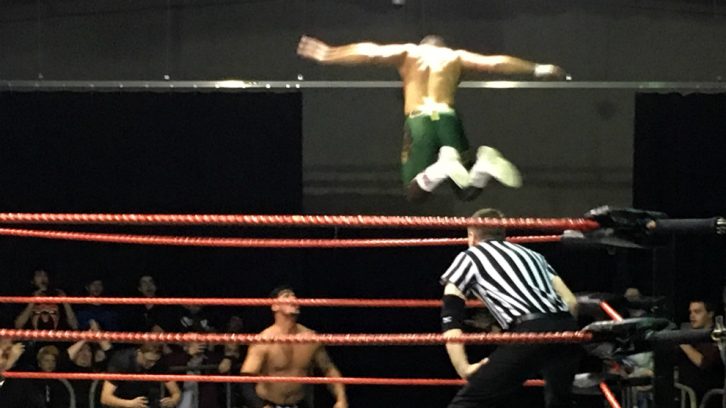 Cody Rhodes (in green) launches a flying attack on Dick Durning.