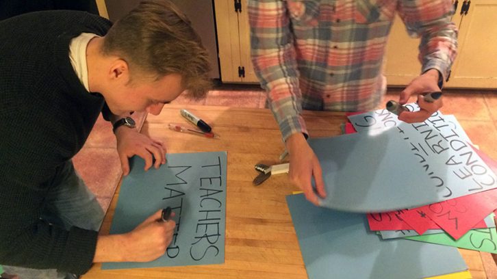 Students make posters after school to prepare for Friday's rally.