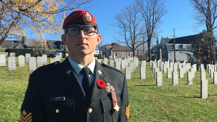 soldier stands in cemetery