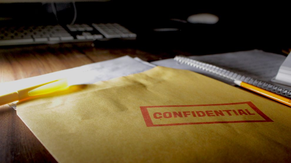 An envelope stamped confidential sits on a desk in this photo illustration.