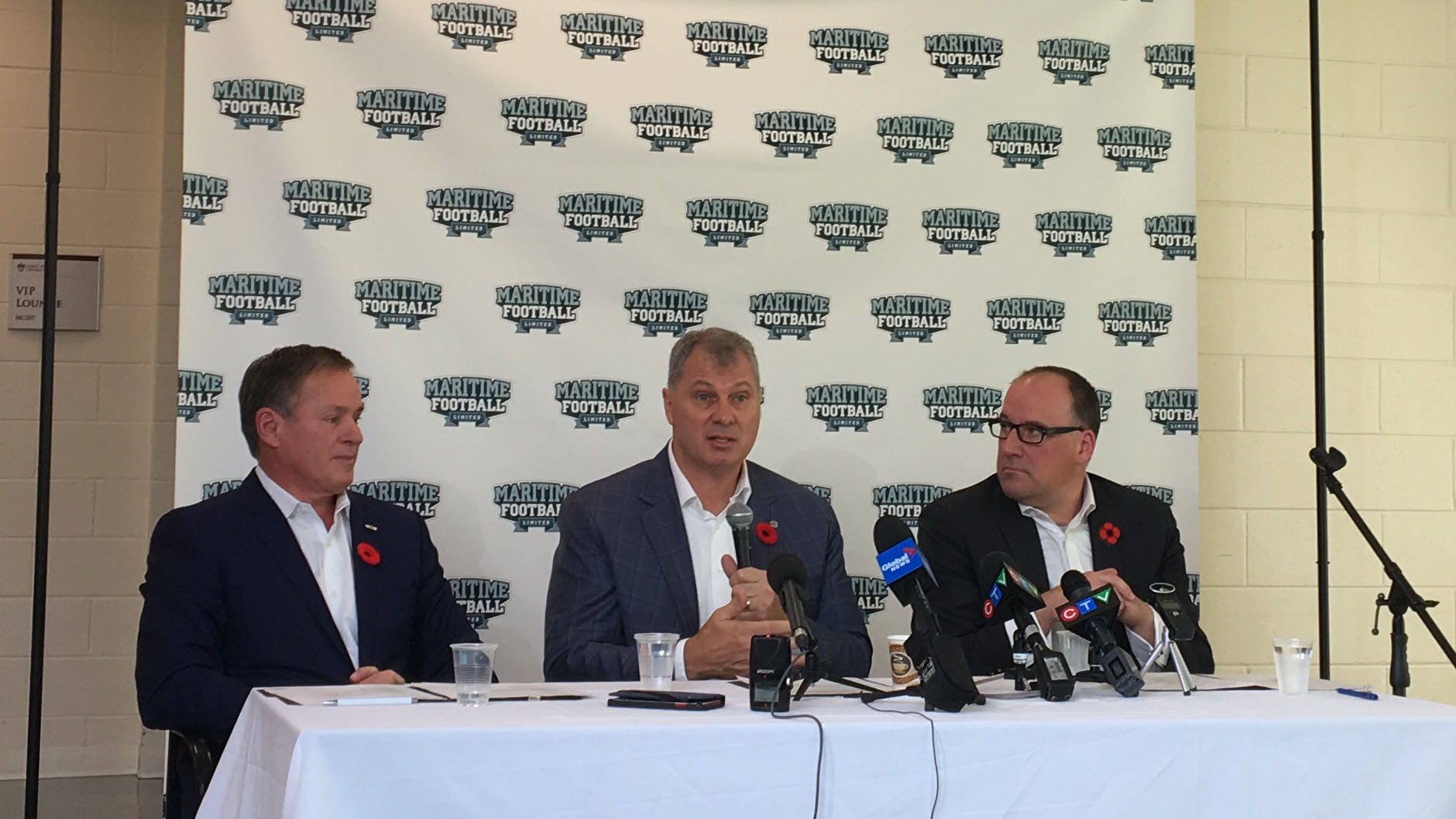 CFL Commissioner Randy Ambrosie (centre) answers questions while Bruce Bowser (left) and Anthony LeBlanc (right) founding partners of Maritime Football Ltd. listen at the Nov. 7 press conference