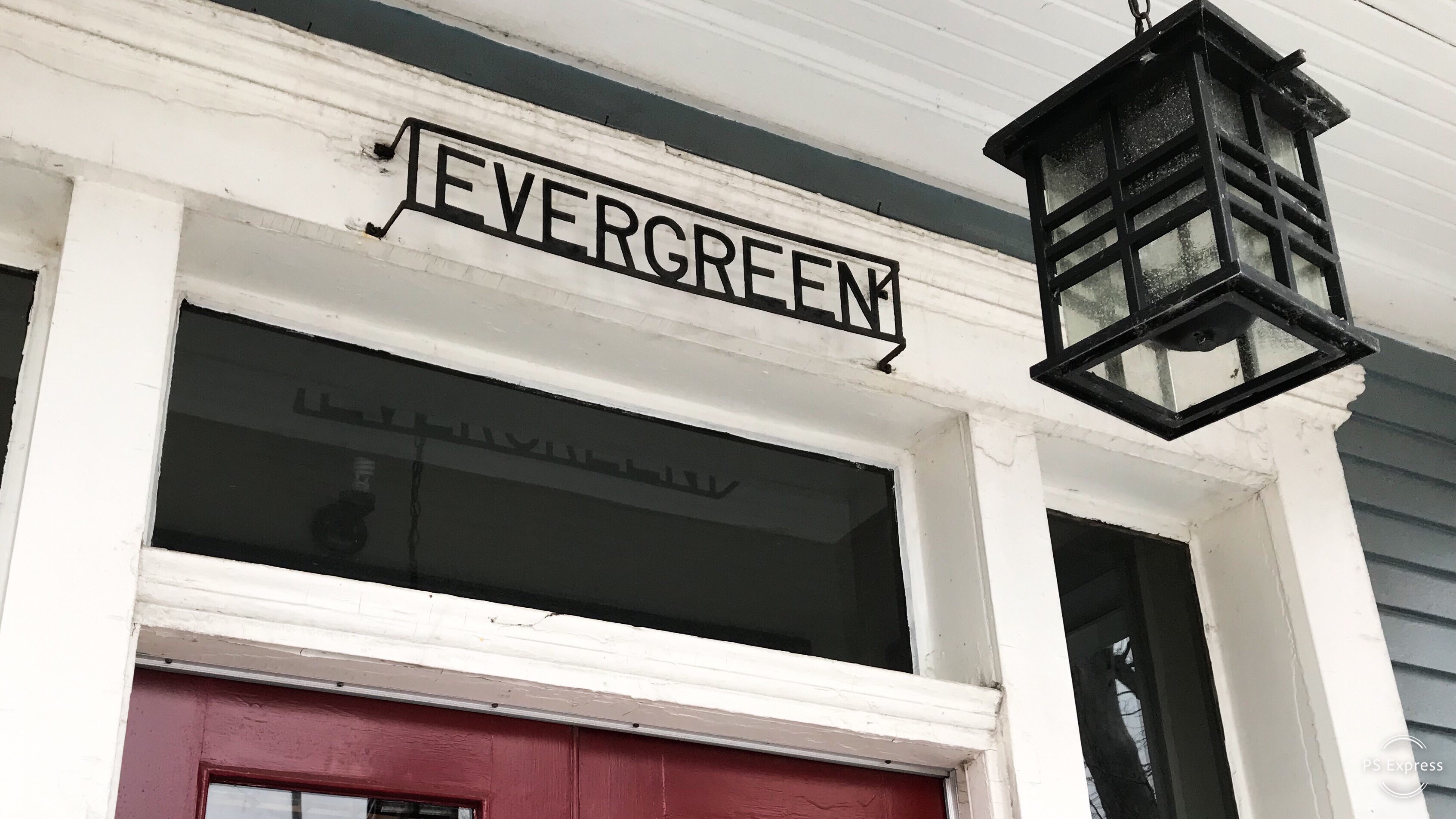 An outside door archway with the house name, Evergreen.