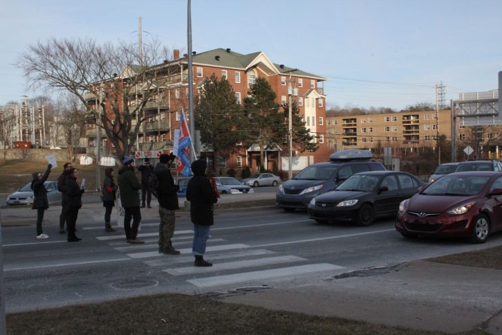 People standing in solidarity on crosswalk