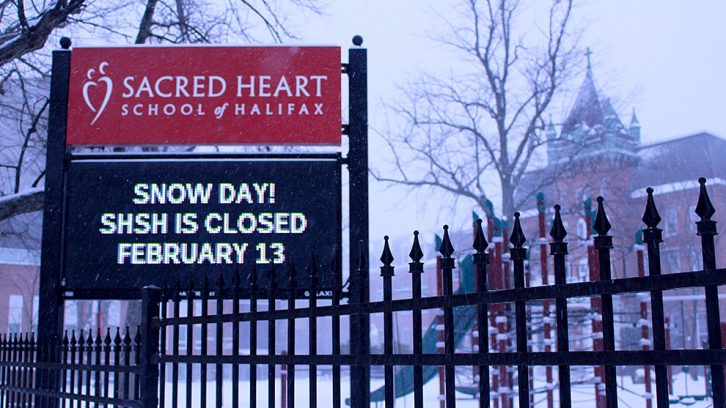 Sign outside of school reads: "Snow day!; SHSH closed; February 13"