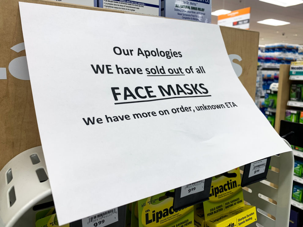 A sign saying a Lawton's is sold out of all face masks.