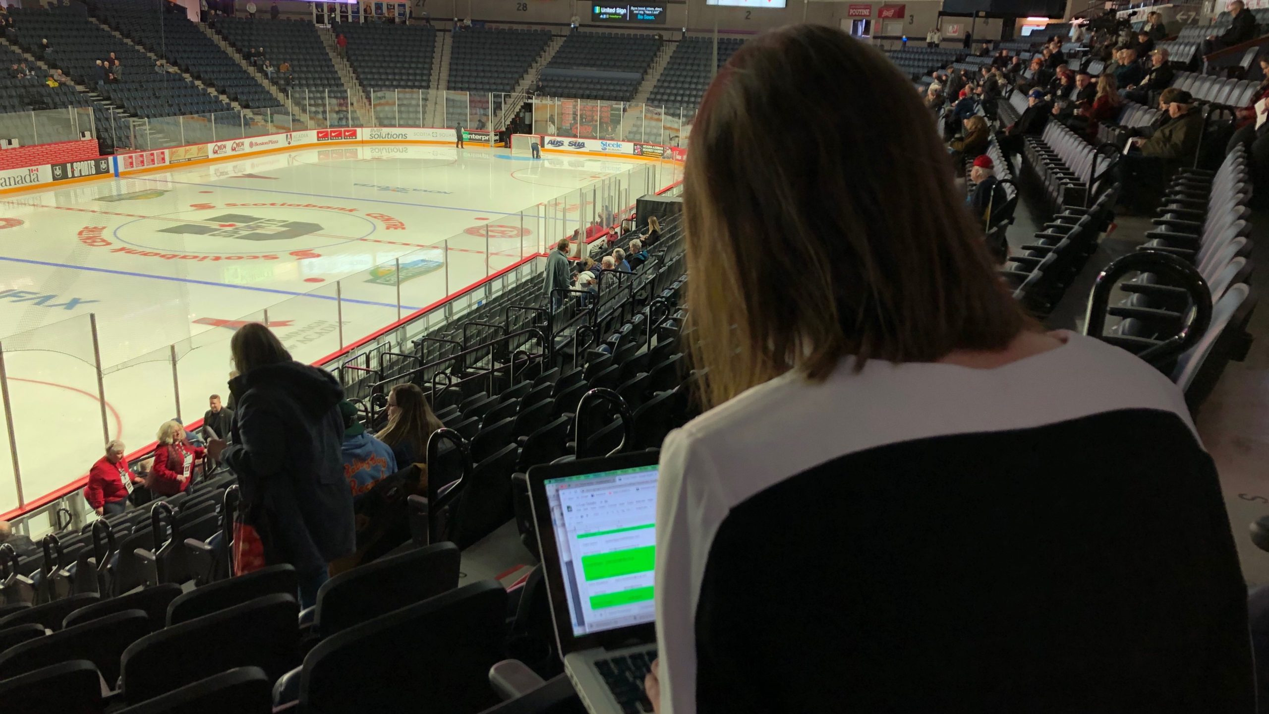 Before the puck drops, Rhéa Koivu catches up on emails. 