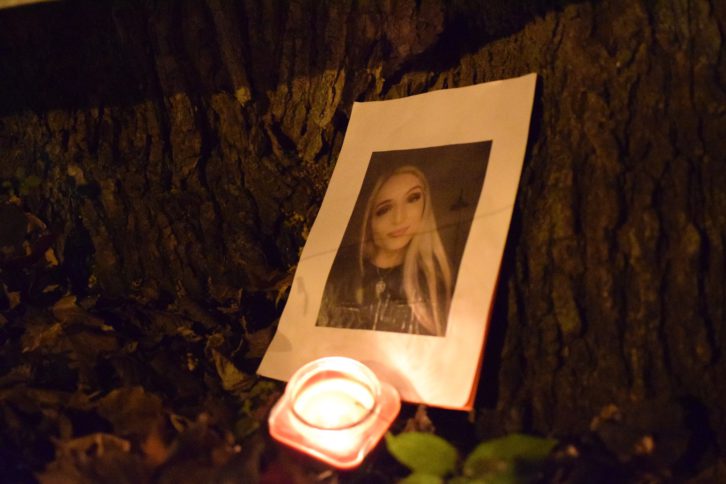 A photo of Rukia Isis Bemer sits under a tree in Raymond Taavel Park.