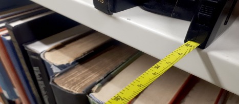 A tape measure shows the width of one of the isles at the Killiam Library. 