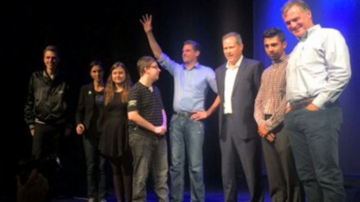 Candidates, student organizers and school staff gathered on stage for photos after pitches. 