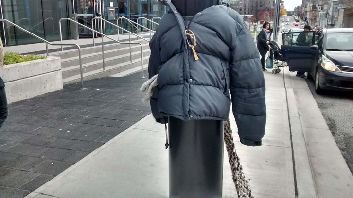 A donated jacket is attached to a light post outside the Halifax library