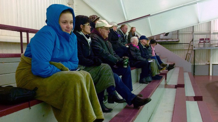 Fans at Saturday's hockey game at Alumni Arena bundle up to keep warm in the rink.