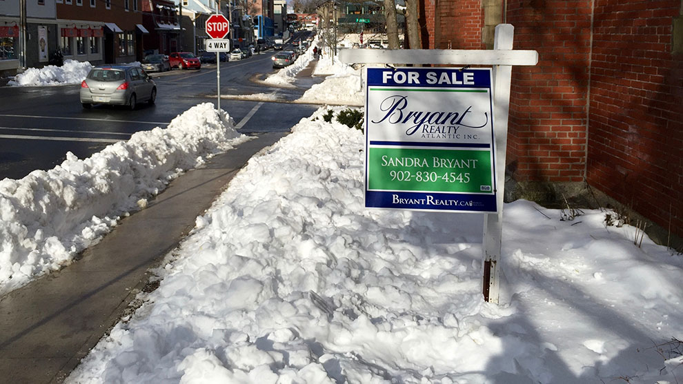 A "for sale" sign blows in the wind along Queen ST. in Halifax, N.S.
