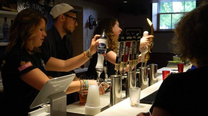 Bartenders at the HMCS Wardroom serving students and professors during their first opening. (Photo: Teri Boates)