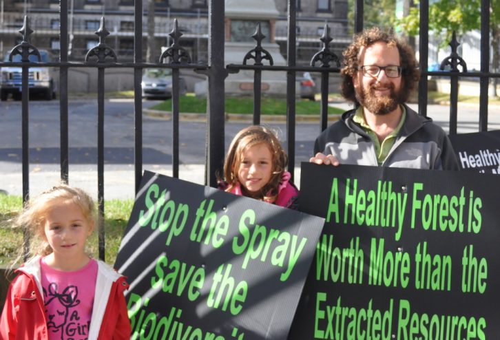 Chad Hoelzel and his daughters Abie and Alyssa were protesting on behalf of Stop the Spray. 