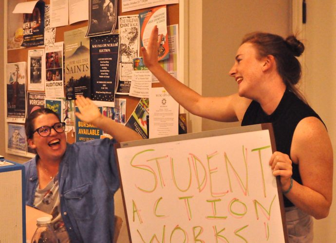 President of the King's Students' Union, Aidan McNally (right) celebrates what she calls a victory for the student movement Thursday.