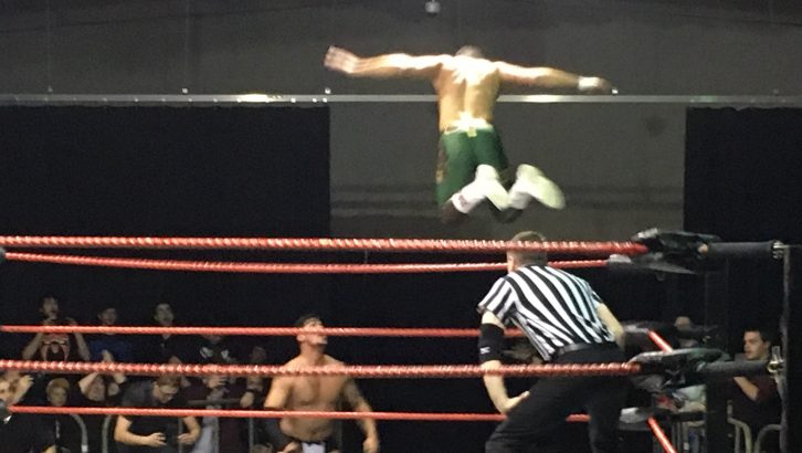 Cody Rhodes (in green) launches a flying attack on Dick Durning.