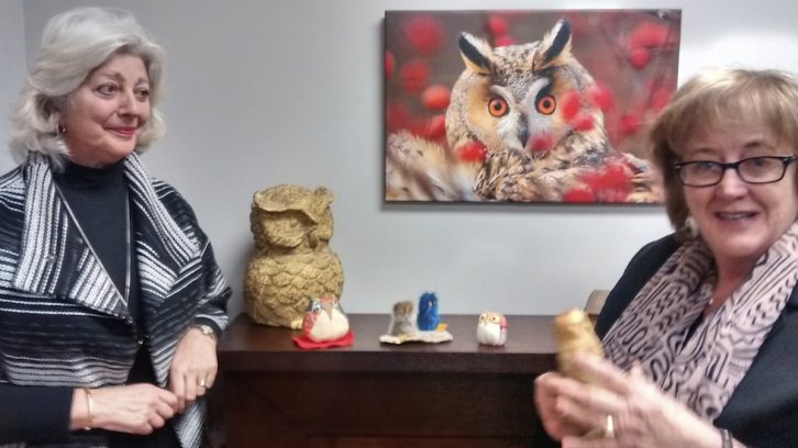 Katherine MacFarlane (left) and Chris Rankin (right) show the collection of owls given to them by graduates of the Older Wiser Labour Force program.