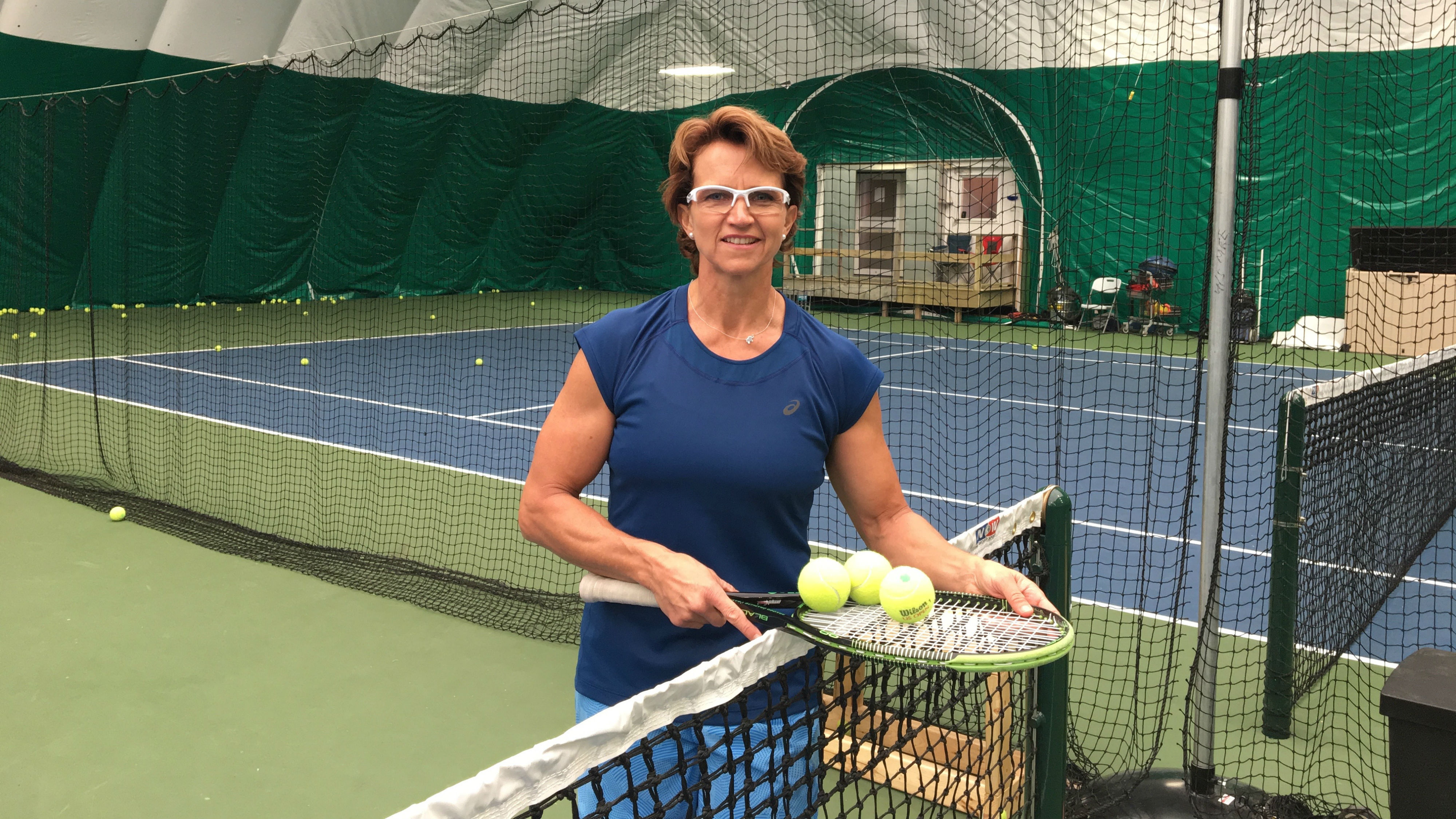 Marijke Nel stands by the net at the HEADStart Tennis Club in Clayton Park. 