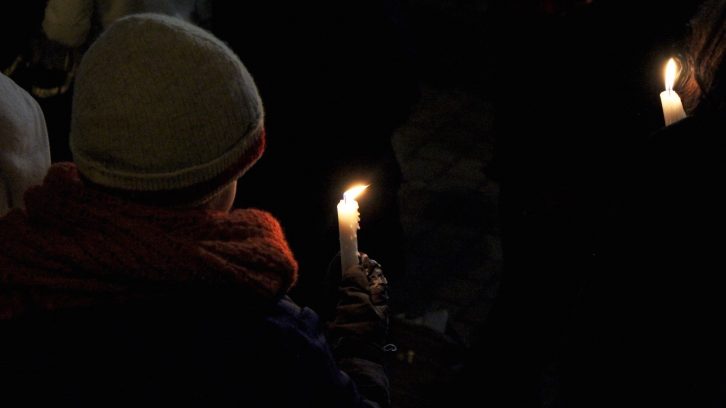 A young attendee holds a candle at the Halifax vigil for the Quebec mosque shooting. 
