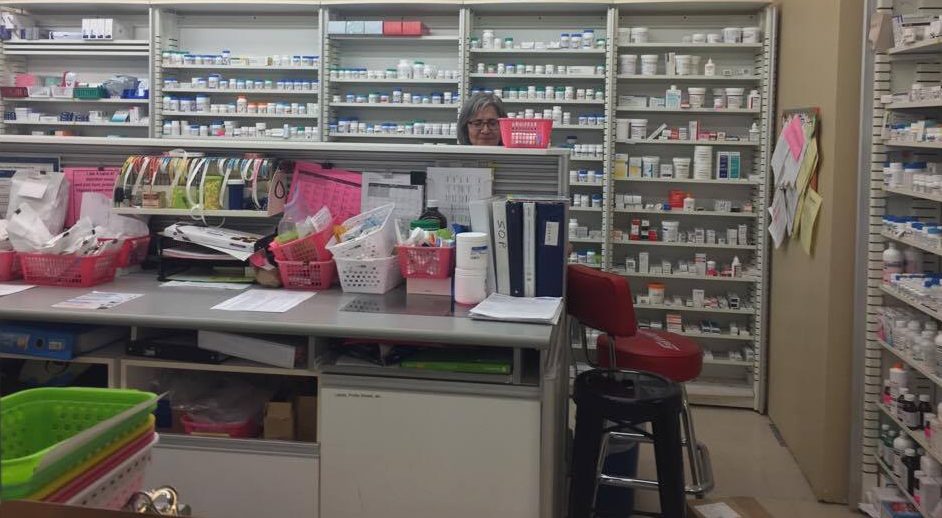 Maria Tasiopoulos working the pharmacy counter at Lawaton's drugstore at Robie and Spring Garden