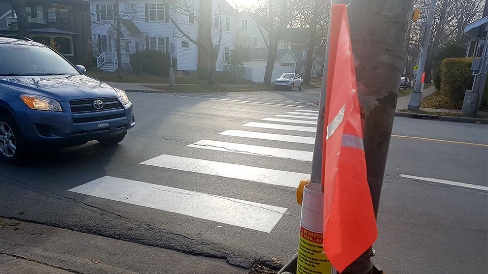 City staff recommended crosswalk flags be removed from locations with overhead amber lights.