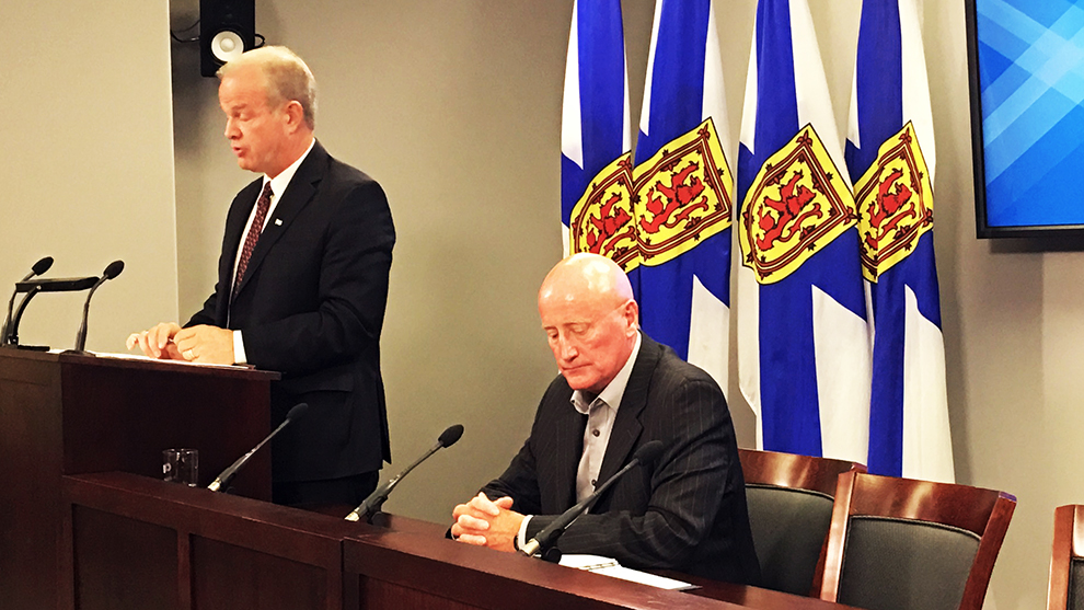 Minister of labour relations Mark Furey (left) and government negotiator Rollie King (right) announced a decision Thursday that wages will increase for NSGEU workers. 