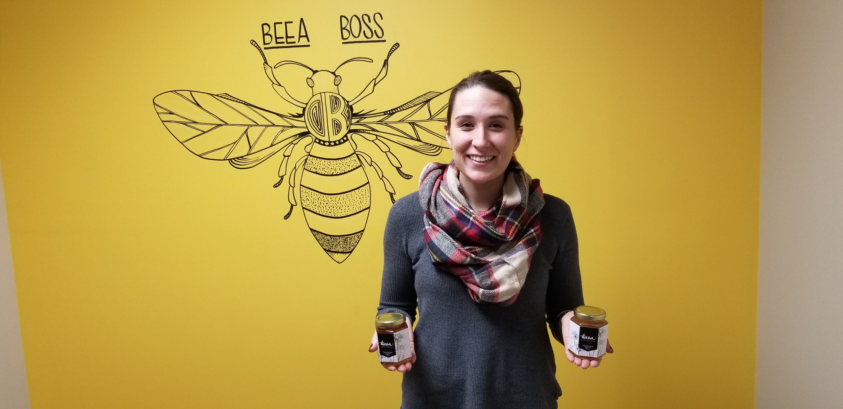 Kimberly Drisdelle, facilitator of BEEA Honey with a Heart, stands with some of the group's honey.