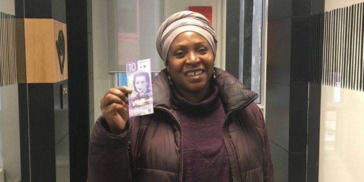 Afua Cooper holds up her new Viola Desmond bill at the Delmore "Buddy" Daye Learning Institute.  