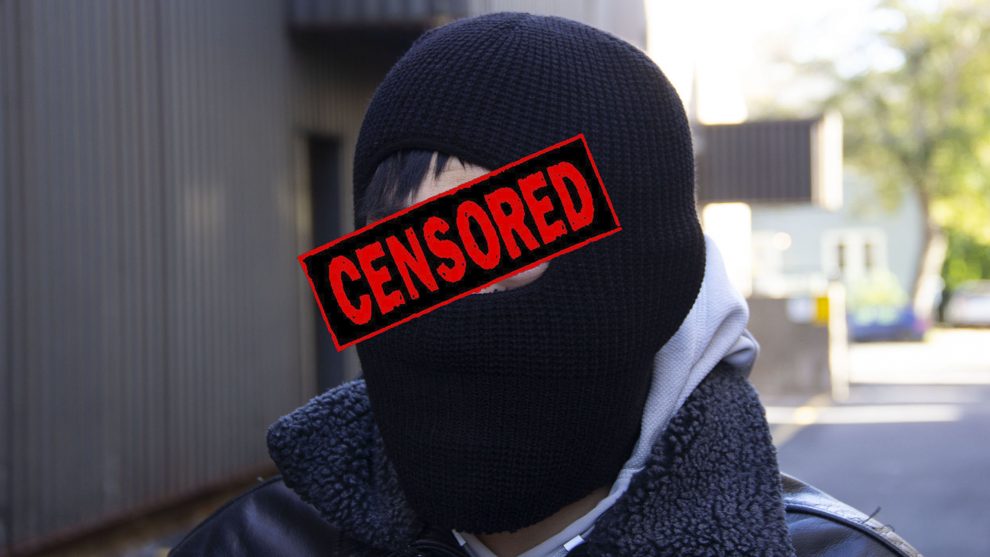 A suspect's face is censored in this photo illustration. 
